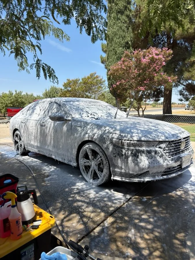 Car covered in foam during a mobile wash in Tulare, CA