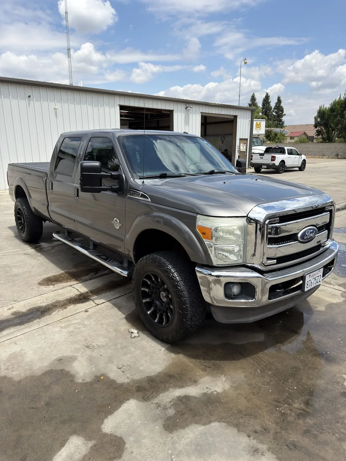 Street Shine Mobile Detailing washing a car in a driveway in Tulare, CA